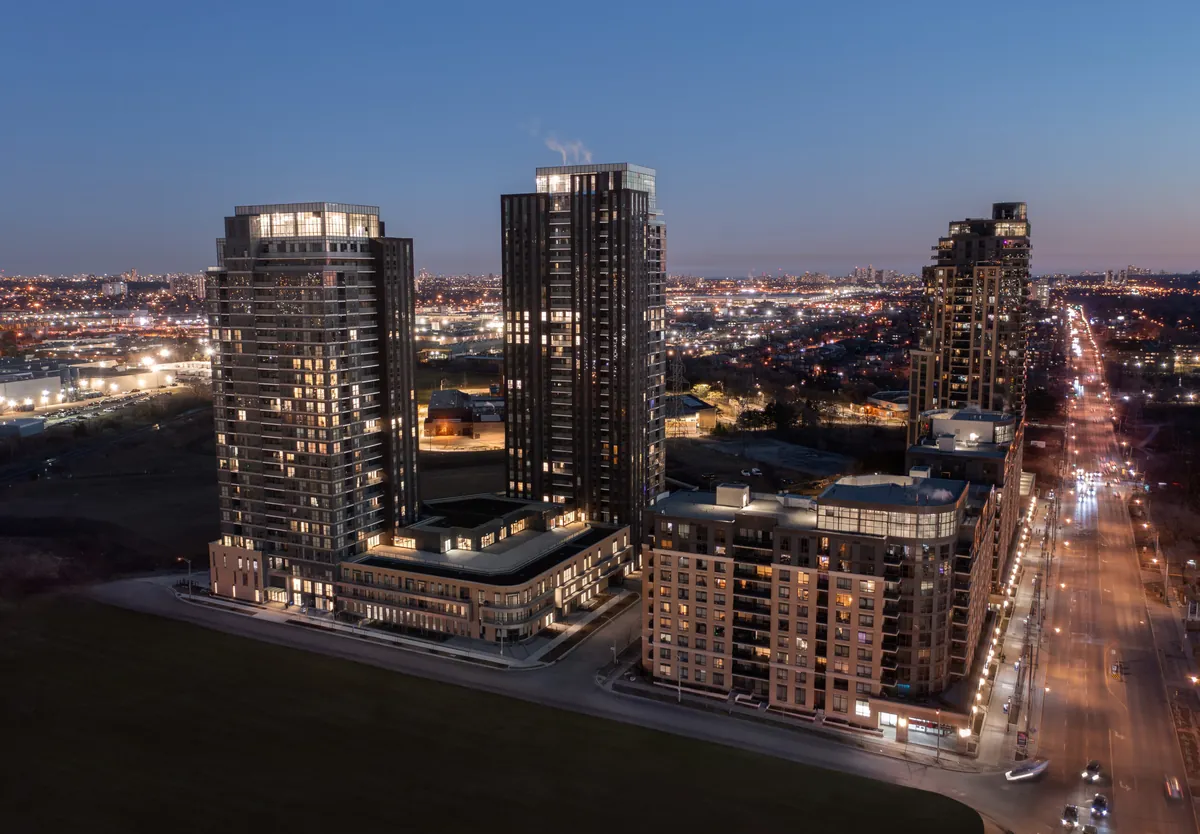 The towers at 15 Vena Way photographed from the air at dusk, with the Toronto skyline on the horizon
