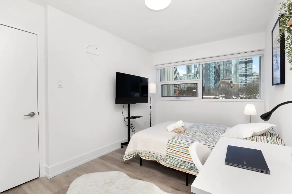 Deluxe bedroom with a wall-mounted television