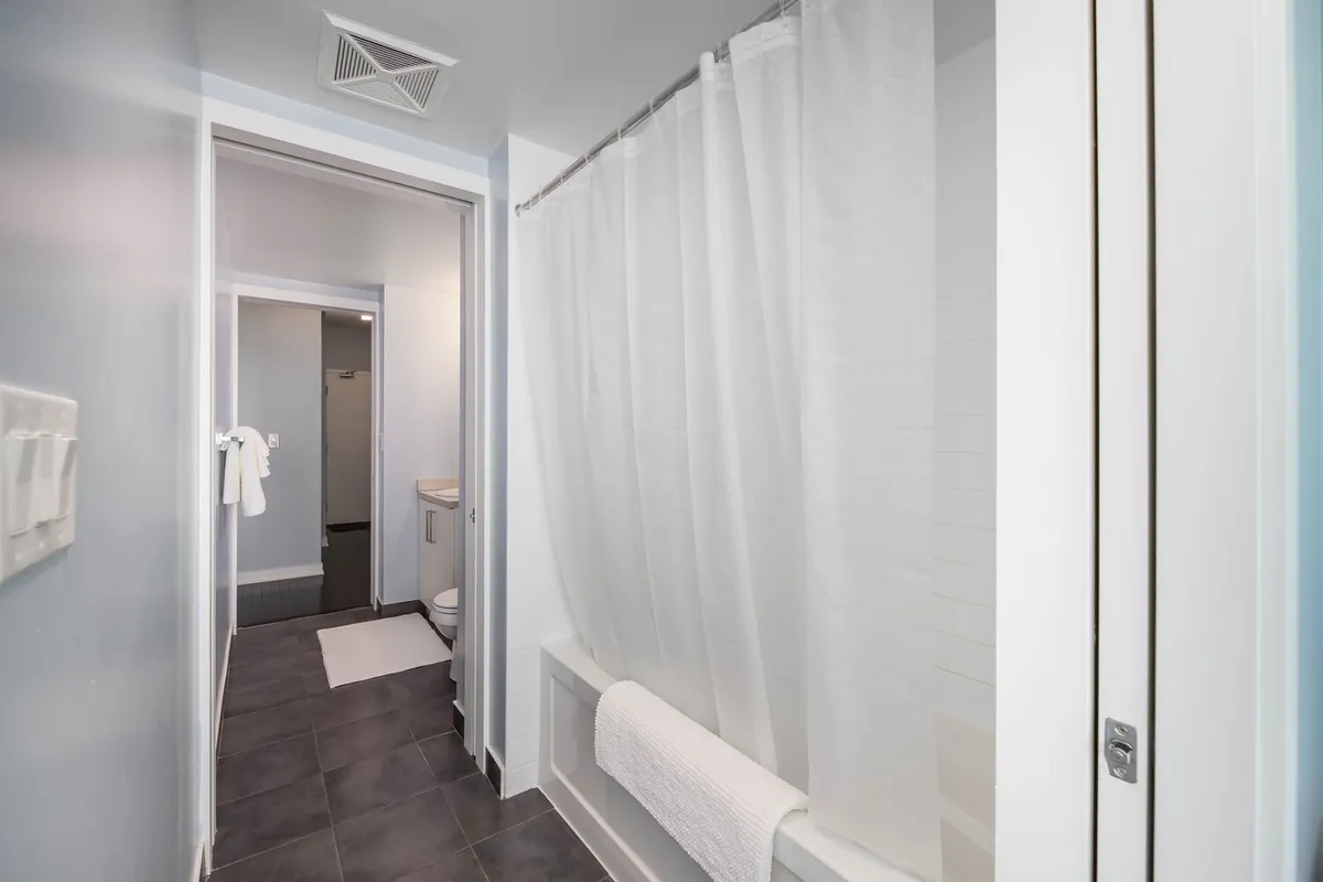 Ensuite bathroom with a bathtub and shower