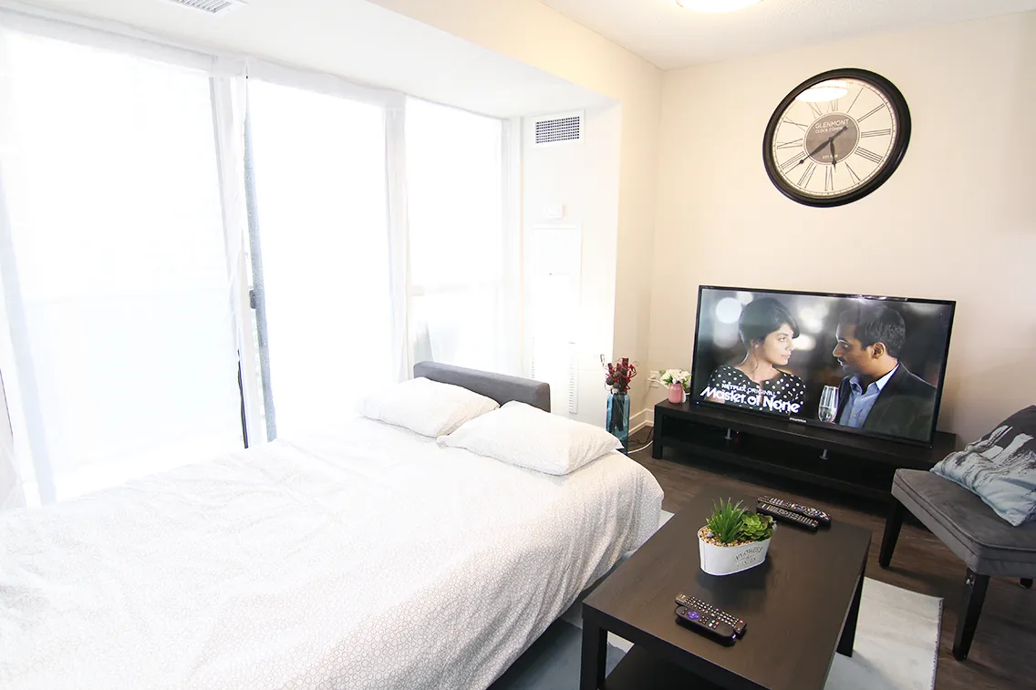 Bedroom view with the television and window