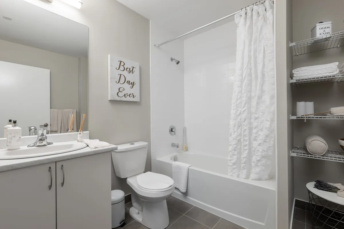 Private ensuite bathroom with a bathtub and shelving